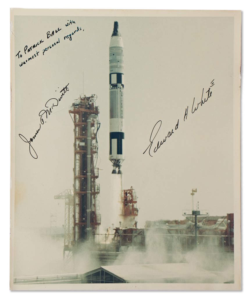 Photo of the Gemini 4 during launch. James A. McDivitt and Edward H. White sign in black marker.