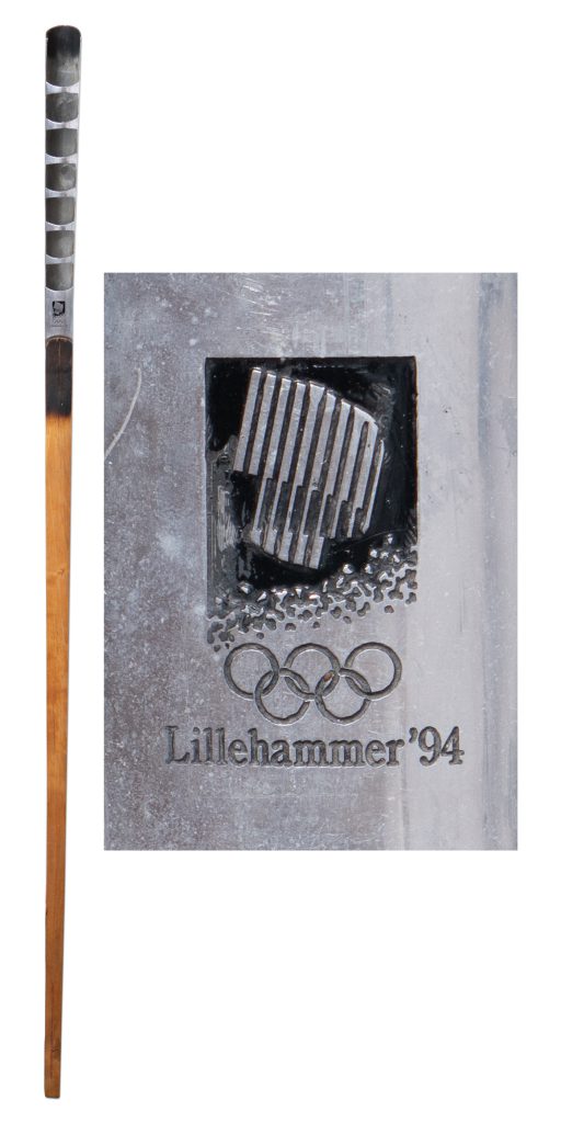 1994 Lillehammer Olympics torch. Birchwood and aluminum/ copper torch measures about 60 inches long. Aluminum blade at the top of torch has the Lillehammer Olympic emblem at base.